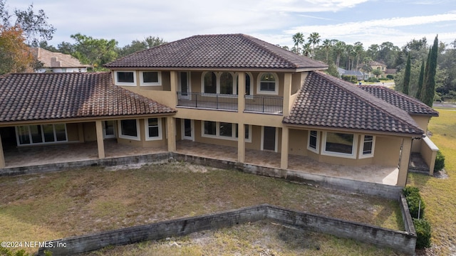 rear view of property with a balcony and a patio