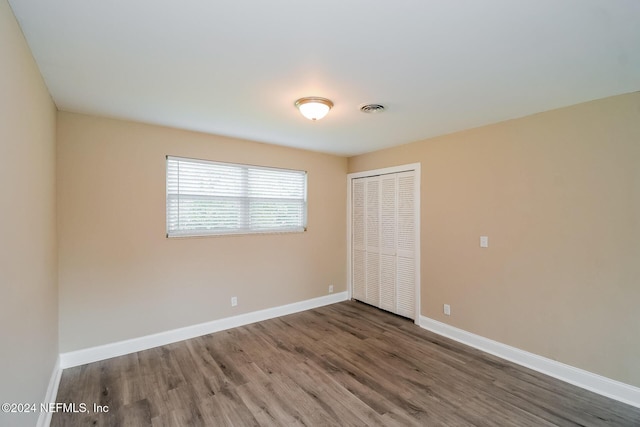 unfurnished room featuring dark hardwood / wood-style flooring