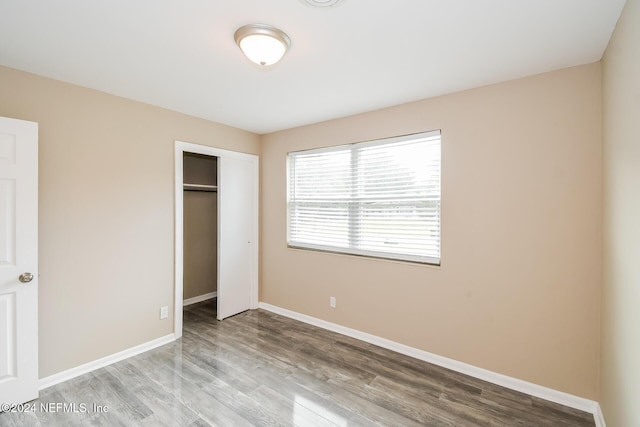 unfurnished bedroom featuring a closet and light hardwood / wood-style flooring