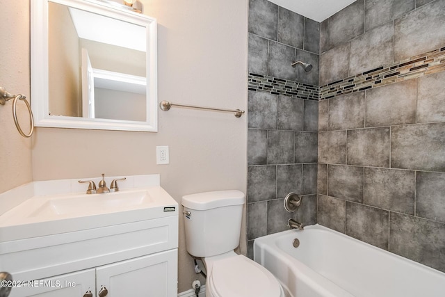 full bathroom featuring tiled shower / bath combo, toilet, and vanity