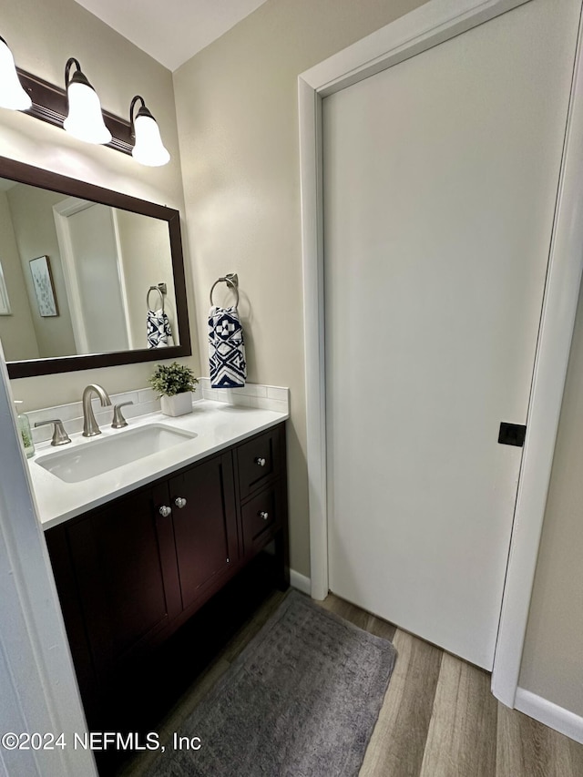 bathroom with hardwood / wood-style flooring and vanity