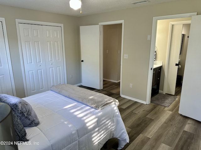 bedroom featuring hardwood / wood-style flooring, a textured ceiling, and ensuite bathroom