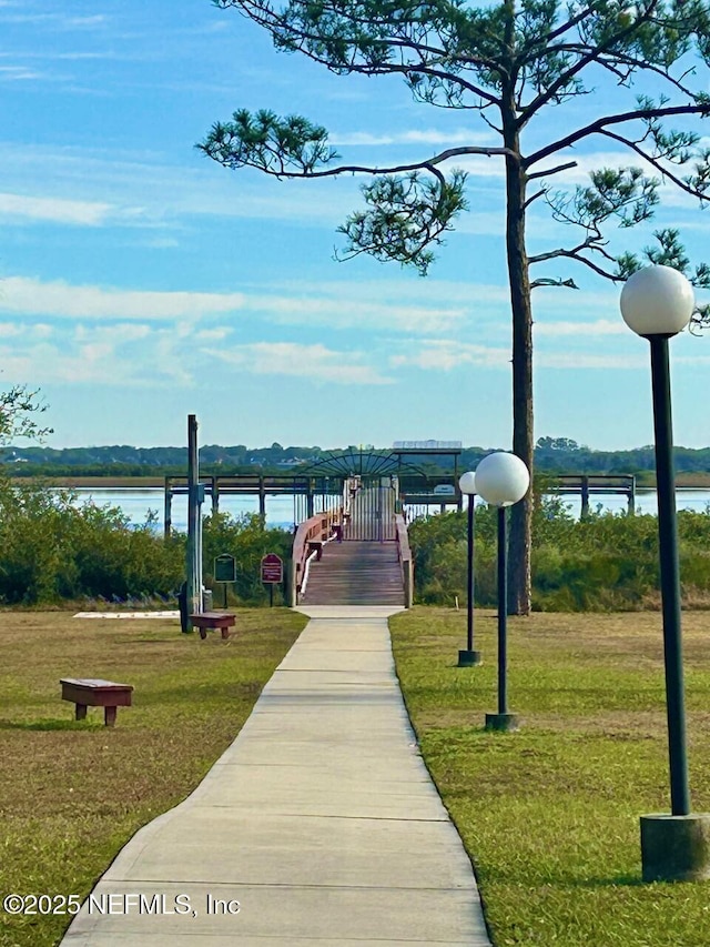 view of property's community featuring a water view and a lawn