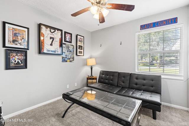 carpeted living room featuring a textured ceiling and ceiling fan