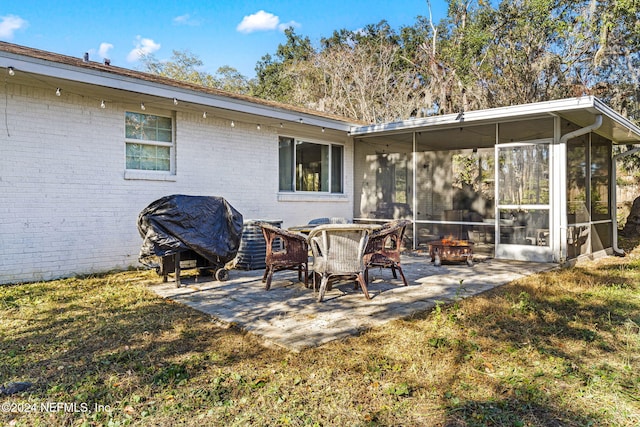 view of patio featuring grilling area and a sunroom