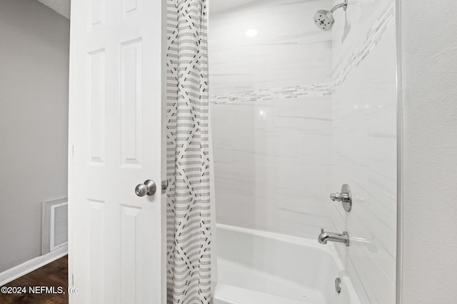 bathroom featuring shower / bath combo and hardwood / wood-style flooring