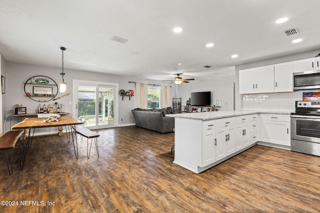 kitchen with pendant lighting, white cabinetry, kitchen peninsula, and appliances with stainless steel finishes