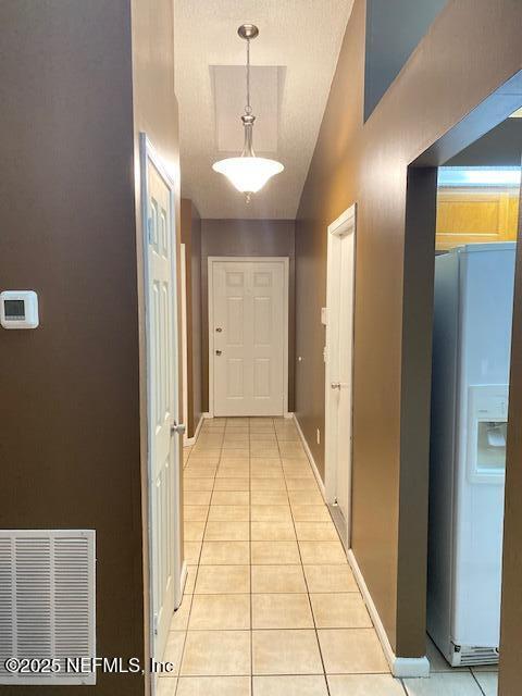 corridor with light tile patterned flooring