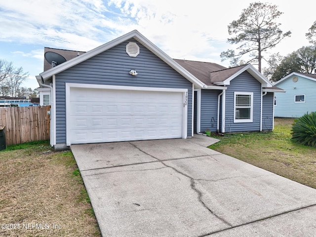 single story home with a garage and a front lawn