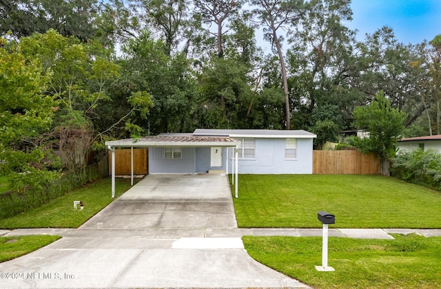 view of front of house featuring a front lawn and a carport