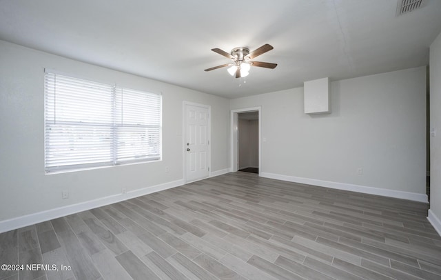 spare room featuring wood-type flooring and ceiling fan