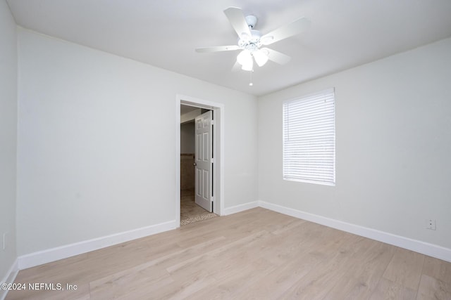 spare room with light hardwood / wood-style flooring and ceiling fan