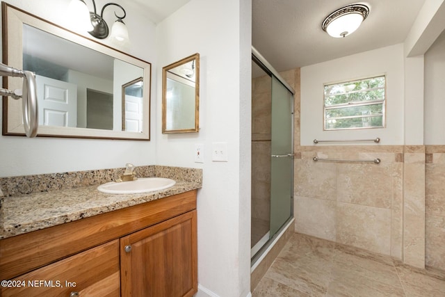 bathroom with vanity, tile patterned floors, and a shower with shower door