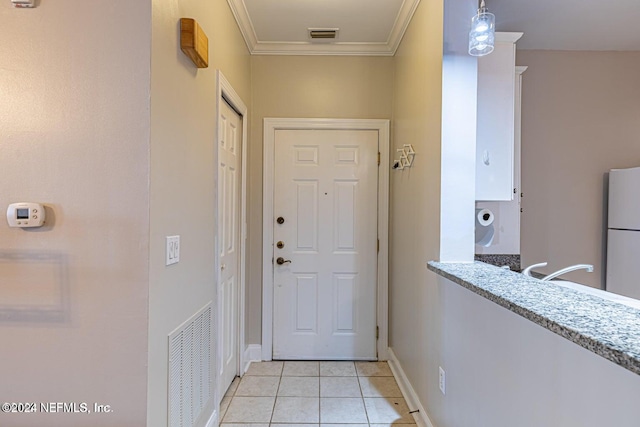 doorway featuring light tile patterned flooring and crown molding