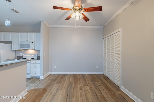 kitchen with light wood-type flooring, white appliances, crown molding, decorative light fixtures, and white cabinetry