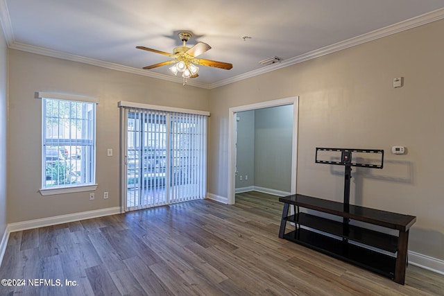 spare room featuring dark hardwood / wood-style flooring, ceiling fan, and crown molding