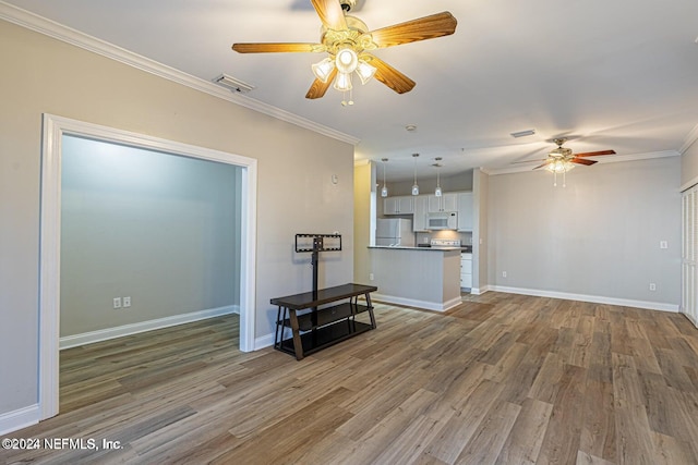 living room featuring hardwood / wood-style flooring, ceiling fan, and crown molding