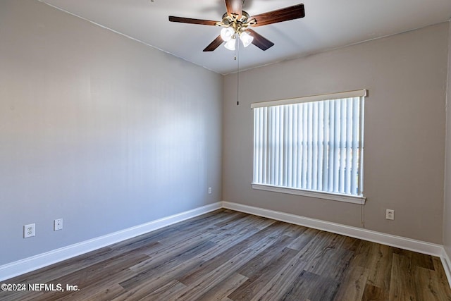 empty room featuring ceiling fan and dark hardwood / wood-style flooring