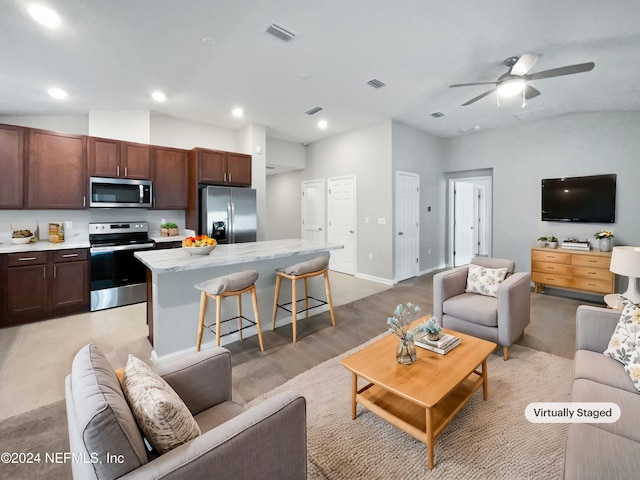 living room featuring ceiling fan, light hardwood / wood-style floors, and lofted ceiling