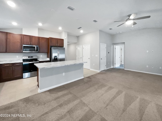 kitchen featuring light carpet, a center island, stainless steel appliances, and vaulted ceiling