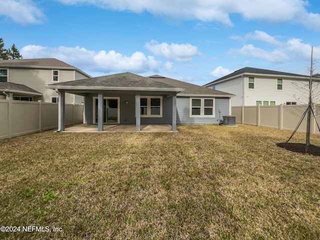 rear view of house featuring a lawn, a patio, and central AC