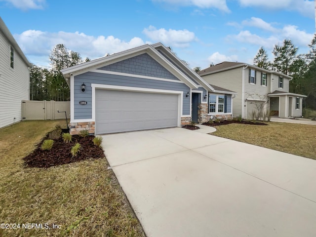 view of front of house featuring a garage and a front yard