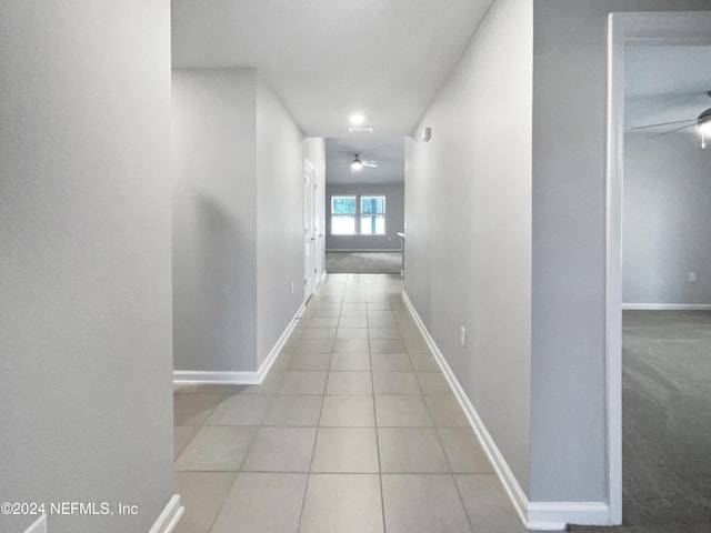 hall featuring light tile patterned floors