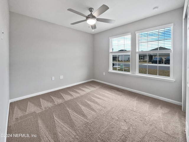 unfurnished room featuring carpet floors and ceiling fan