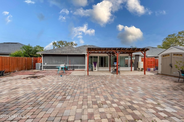 rear view of property with central AC, a pergola, and a patio