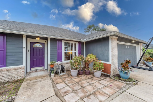 view of exterior entry with a garage