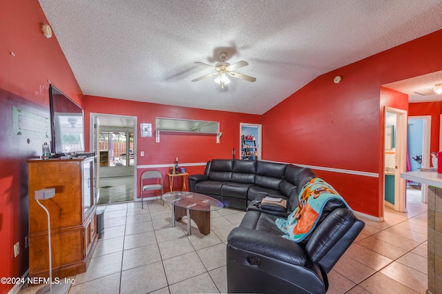 living room featuring a textured ceiling, vaulted ceiling, and light tile patterned flooring