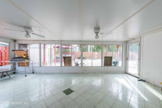 unfurnished sunroom with a wealth of natural light and ceiling fan