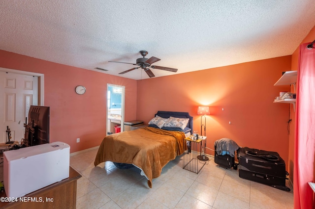 bedroom with a textured ceiling and ceiling fan