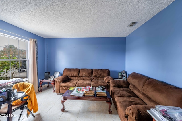 tiled living room with a textured ceiling