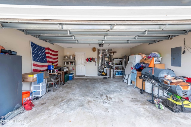 garage featuring electric panel and a garage door opener