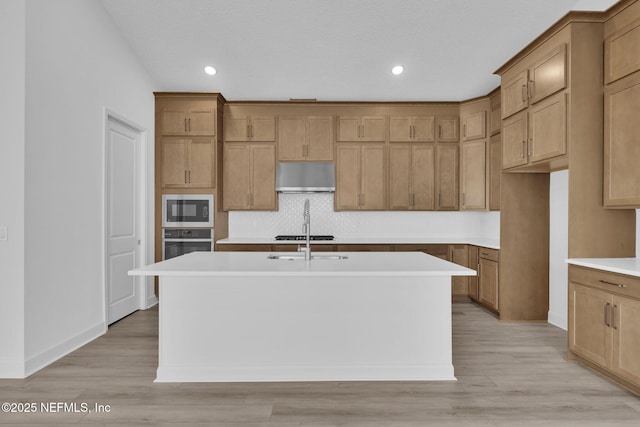 166 Blue Hampton Dr, Ponte Vedra, FL 32081 - kitchen with built in microwave, oven, under cabinet range hood, a center island with sink, and tasteful backsplash