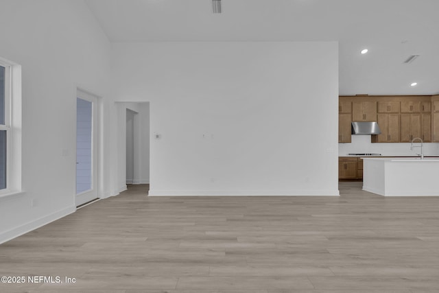 166 Blue Hampton Dr, Ponte Vedra, FL 32081 - unfurnished living room with light wood-style floors, recessed lighting, and baseboards