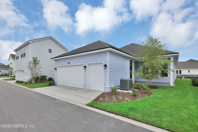 166 Blue Hampton Dr, Ponte Vedra, FL 32081 - view of side of property featuring concrete driveway, a garage, central AC, a yard, and roof with shingles