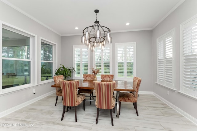 dining room with ornamental molding and a notable chandelier