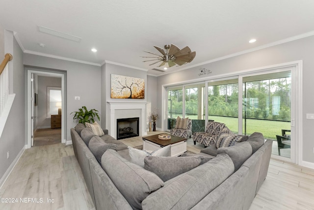 living room featuring light hardwood / wood-style flooring, ceiling fan, and ornamental molding