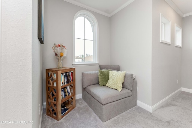 living area with light carpet and ornamental molding