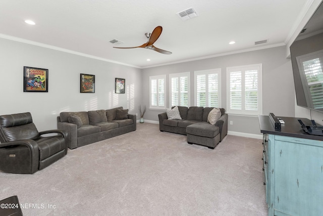 living room with ceiling fan, crown molding, and light colored carpet