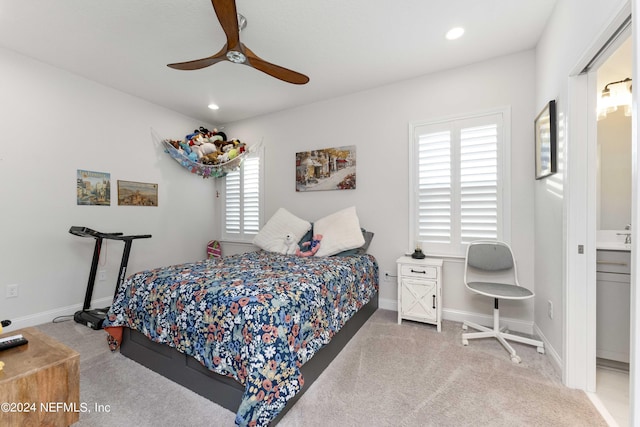 carpeted bedroom with connected bathroom and ceiling fan