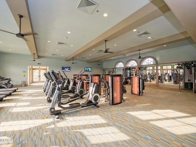 gym with light colored carpet and ceiling fan