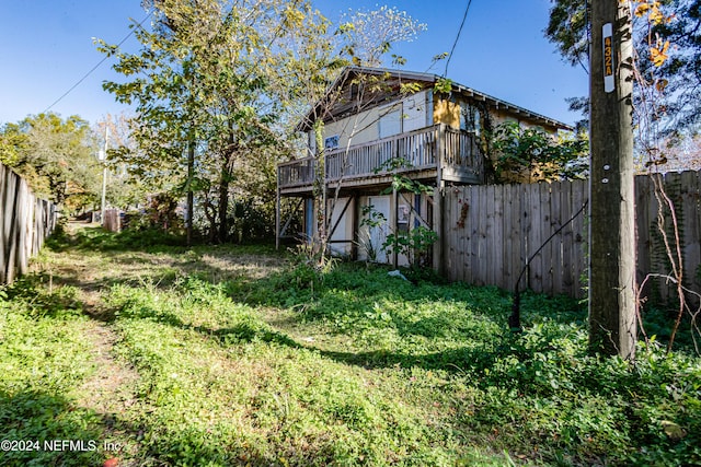 view of yard with a garage and a wooden deck