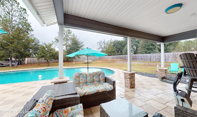 view of swimming pool featuring outdoor lounge area, a patio area, and a lawn