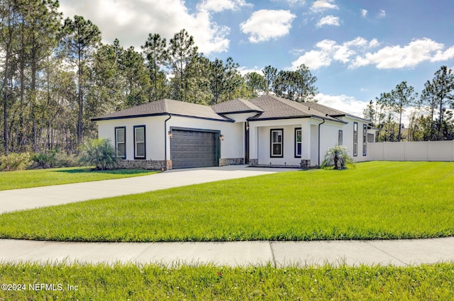 view of front of house with a front yard and a garage