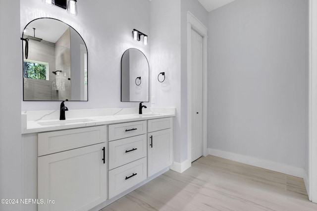 bathroom with a shower and vanity