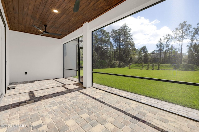 unfurnished sunroom featuring ceiling fan and wooden ceiling