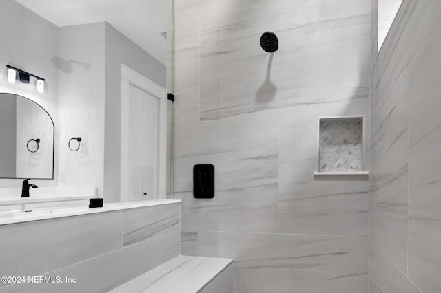 bathroom featuring vanity and tiled shower